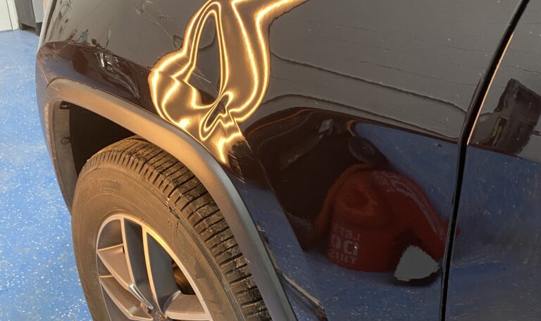 Front fender body-line dent before paintless dent repair